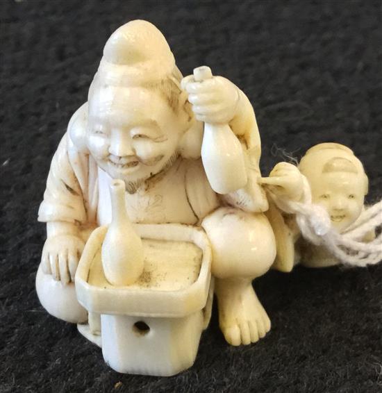 A Japanese ivory netsuke of Ebisu and a boy, Meiji period, 3.4cm, boys left arm lacking